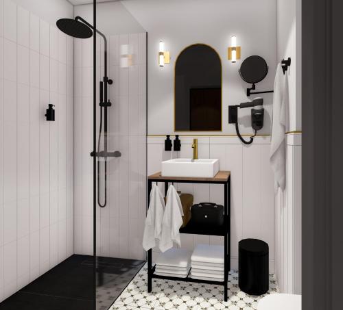 a bathroom with a shower with a sink and a mirror at Apartamenty Branicka in Białystok