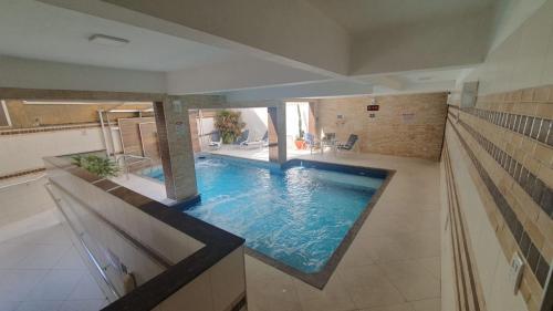 a large swimming pool in the middle of a house at Presidente Hotel in Poços de Caldas