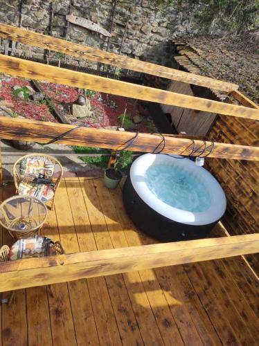 a bath tub sitting on top of a wooden deck at Kucica za odmor Lena I Matija in Sremski Karlovci