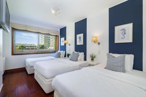 a hotel room with two beds and a window at WHome Luxury Living by the Sea: Matosinhos Marvel in Matosinhos