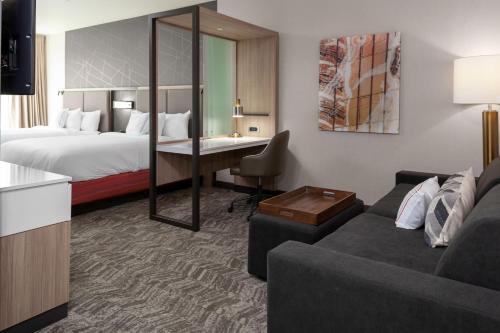 a hotel room with a bed and a couch at SpringHill Suites by Marriott Denver Tech Center in Greenwood Village