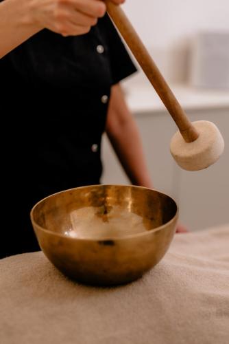 a person is stirring a bowl with a wooden spoon at THE FLAG HOTEL Marbella, Estepona Adult Recommended in Estepona