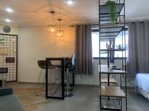 a living room with a table and a spiral staircase at Get a Flat 1009 Luxuoso - Bienal in Sao Paulo