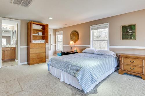 a bedroom with a bed and a dresser and windows at Pet-Friendly Rutherfordton Home with Deck and Views! in Rutherfordton