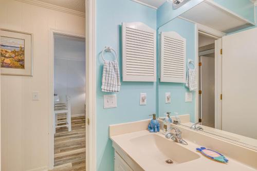 a bathroom with a sink and a mirror at Chic Condo with Ocean Views and Pool - Walk to Beach! in Atlantic Beach