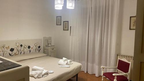 a bedroom with a bed with towels on it at Villa Panorama Exclusive Pool in Loro Ciuffenna