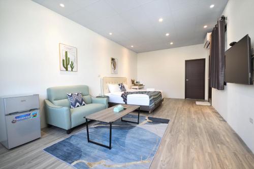 a living room with a couch and a table at Full house in Taitung City