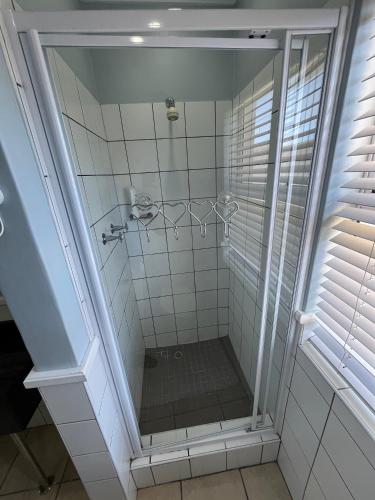 a bathroom with a shower with a glass door at Pinnacle Lodge 1089 in Dana Bay