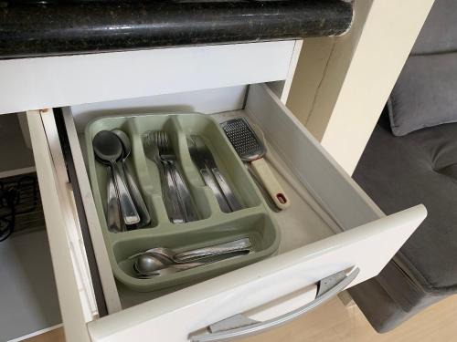 a drawer filled with utensils in a cabinet at Get a Flat 1205 Bienal - Ibirapuera in Sao Paulo