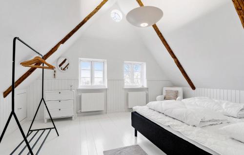 a white bedroom with a large bed and a dresser at Cozy Home In Sydals With Sauna in Sarup