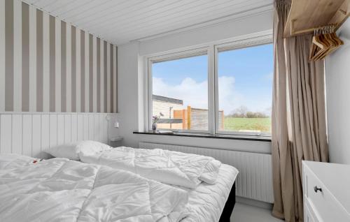 a white bedroom with a bed and a window at Cozy Home In Sydals With Sauna in Sarup