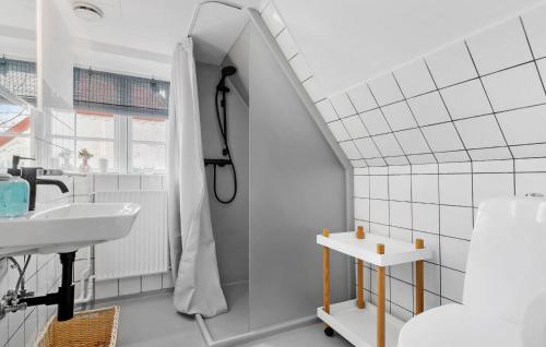 a white bathroom with a sink and a shower at Cozy Home In Sydals With Sauna in Sarup