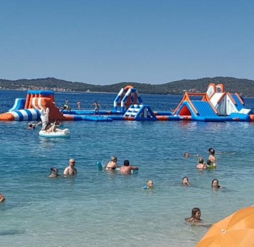 a group of people in the water at a water park at Apartman Daria in Bibinje