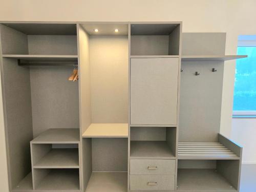 an empty closet with white shelves and cabinets at A&A Rooms in Anacapri