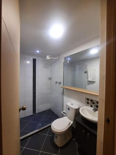 a bathroom with a toilet and a sink at Cozy Apartment in Historic Prado with adjustable desk and 4K Monitor in Medellín