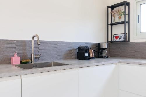 a kitchen with a sink and a counter top at Cozy 2BR Heart in Tel Aviv in Tel Aviv