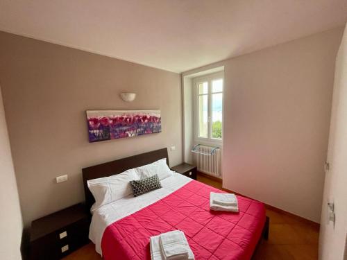 1 dormitorio con 1 cama con manta roja en Appartamento Ai Crotti, en Dervio
