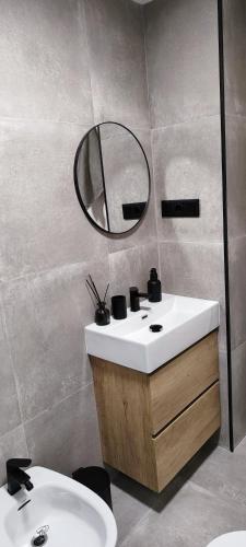 a bathroom with a sink and a mirror at PARQUE AROMATICO CON DOS PISCINAS in Torrevieja