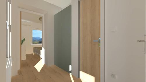 a room with a hallway with a door and a window at Balatonic Lime apartmanház in Siófok