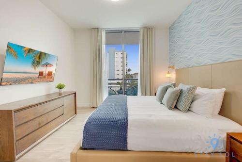 a bedroom with a bed with a view of the beach at Rooftop Pool & Hot Tub - Gym - Hollywood Beach in Hollywood