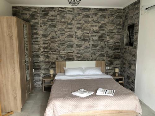a bedroom with a bed with two towels on it at Apartments Samardzic in Kotor