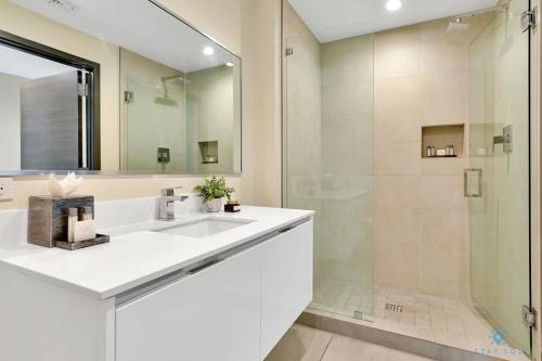 a bathroom with a white sink and a shower at Beachfront Condo-ROOFTO POOL- 2 BEDROOMS 2 BR ! in Hollywood