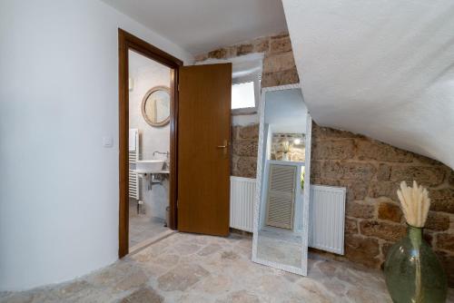 a bathroom with a mirror and a sink in a room at Manero in Trogir