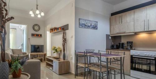 a kitchen and living room with a table and chairs at Comfy Central Square Gem with Balcony in Kalamata