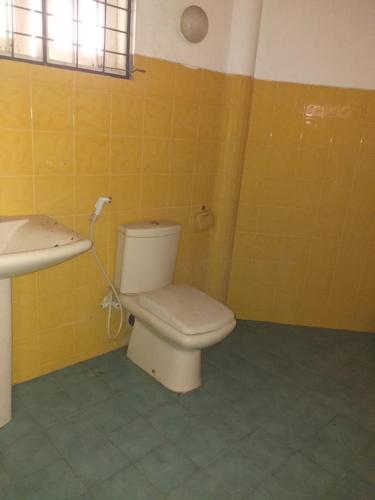 a bathroom with a toilet and a sink at Kahuna Hotel in Unawatuna