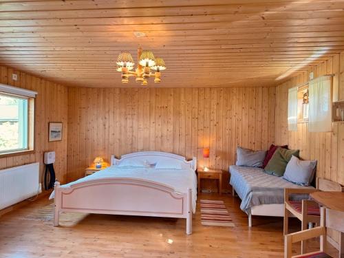 a bedroom with a bed and a couch in a room at Sam Arctic in Övertorneå