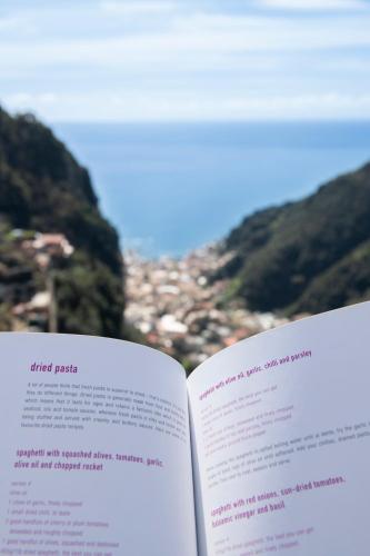 an open book with a view of a mountain at Donna Luisa Suite 9 Amalfi sea view - free parking in Scala
