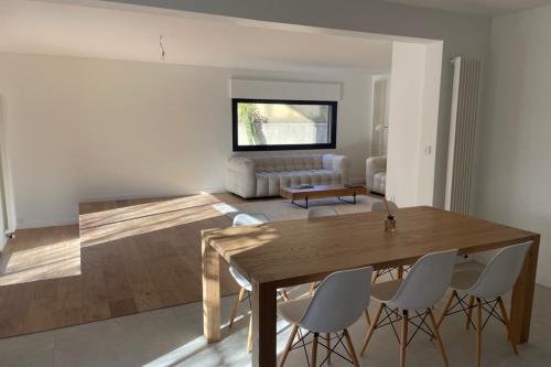 - un salon avec une table et des chaises en bois dans l'établissement Minimalist house with pool, aux Angles (Gard)