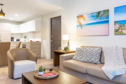a living room with a couch and a table at NEW LUXURY Beachfront Condo Resort in Hollywood