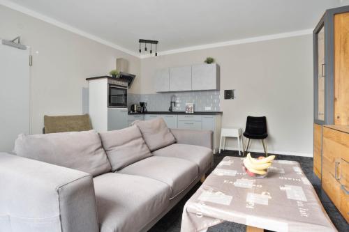 a living room with a couch and a table at Stilvolle Apartments in Bonn I home2share in Bonn