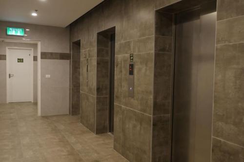 a hallway with elevators in a building at Beach front luxury apartment - managed building in H̱adera