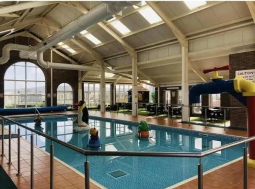 a large swimming pool with a water slide at Two x 8 Berth static caravan on Lyons Robin Hood Rhyl North wales in Meliden