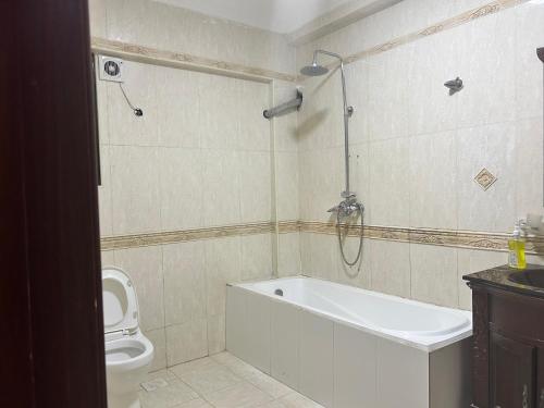 a bathroom with a bath tub and a toilet at Slipway Seaview in Dar es Salaam
