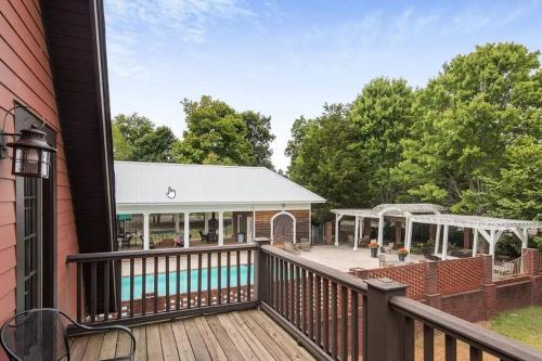 an outdoor deck with a pool and a house at Quiet Getaway at Wayward Cottage in Pisgah