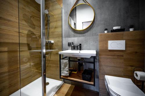 a bathroom with a sink and a shower and a mirror at Apartments Portarata in Pula