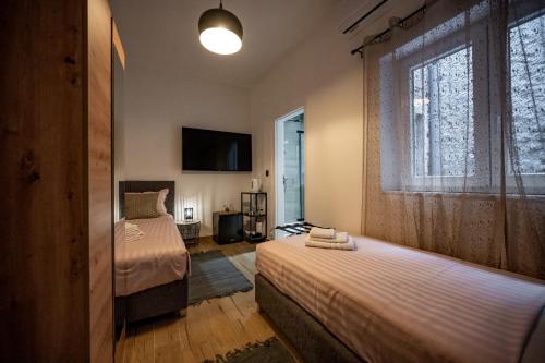 a bedroom with two beds and a window at Apartments Portarata in Pula