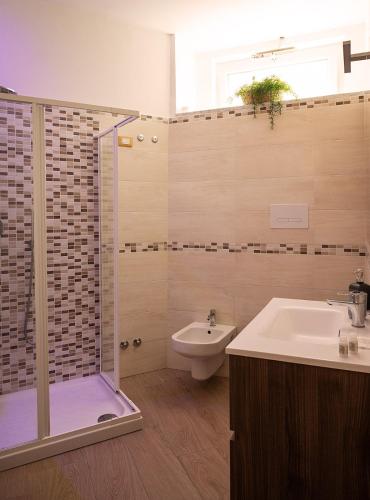 a bathroom with a shower and a sink and a toilet at Domus Cuomo B&B in Nocera Inferiore
