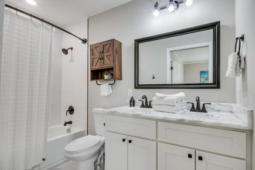 a bathroom with a sink and a toilet and a mirror at Updated Columbia Home with Patio - 4 Mi to USC! in Columbia
