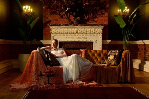 a woman laying on a couch in front of a fireplace at Sacred Mansion in Göreme