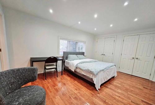 a bedroom with a bed and a desk and a chair at Beautiful Room at Yonge and Sheppard and North York Centre in Toronto