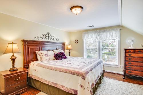 een slaapkamer met een bed, een dressoir en een raam bij Aiken Apt with Garden-View Balcony Half-Mi to Dtwn! in Aiken