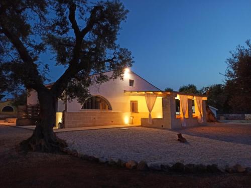 a church at night with a tree in the foreground at Italianway - Villa Butticchio in Serranova
