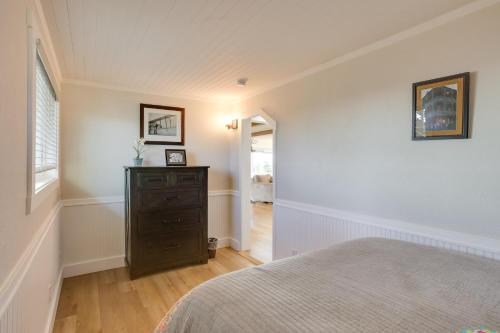 a bedroom with a bed and a dresser at Scenic Tacoma Apartment with Deck and Fire Pit! in Tacoma