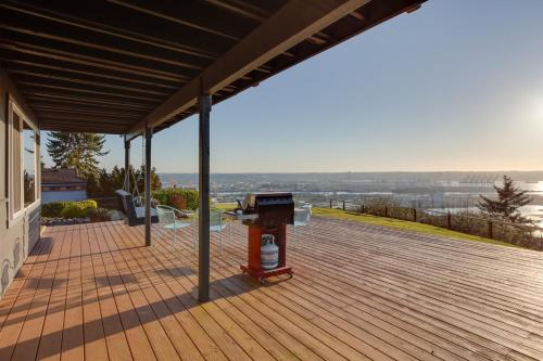 a deck with a grill on top of a house at Scenic Tacoma Apartment with Deck and Fire Pit! in Tacoma