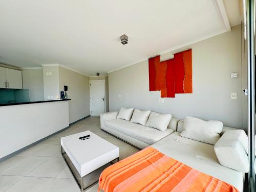 a living room with a couch and a table at Ocean drive 2 full amenities in Punta del Este