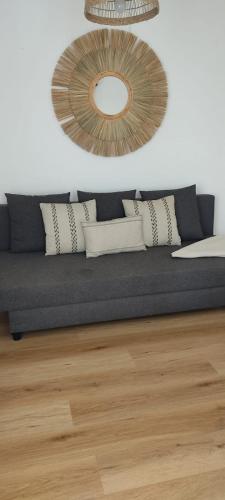 a living room with a blue couch and a mirror at Apartamentos Can Salas in Cala Figuera